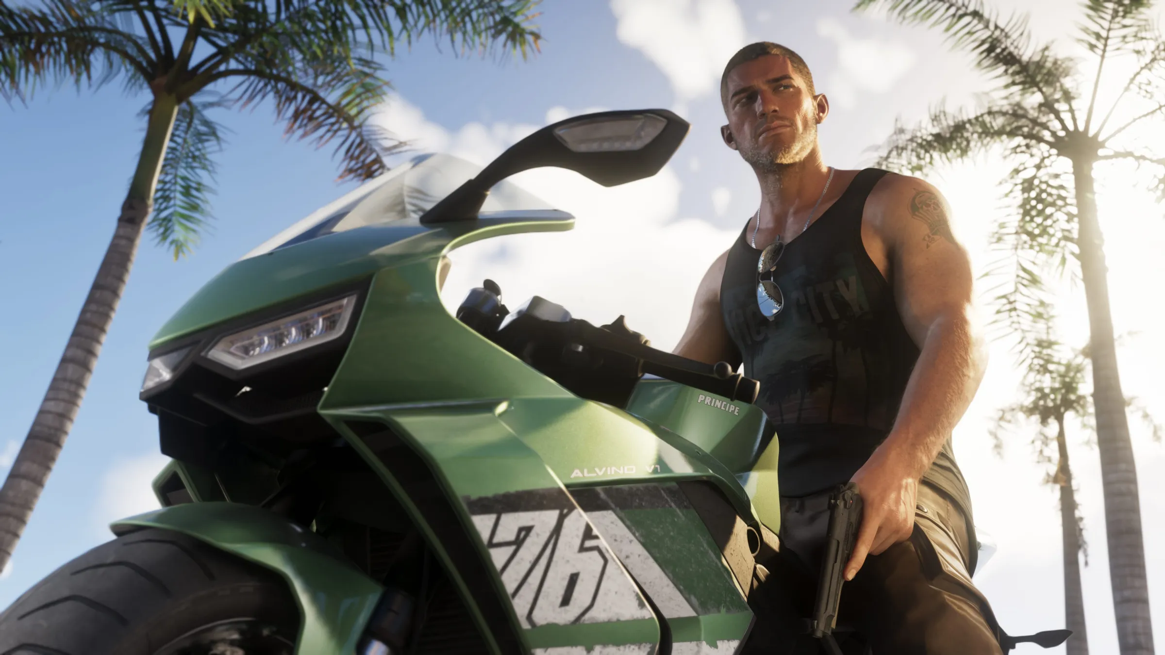 Jason stands beside a green sport motorcycle under palm trees in bright tropical daylight.