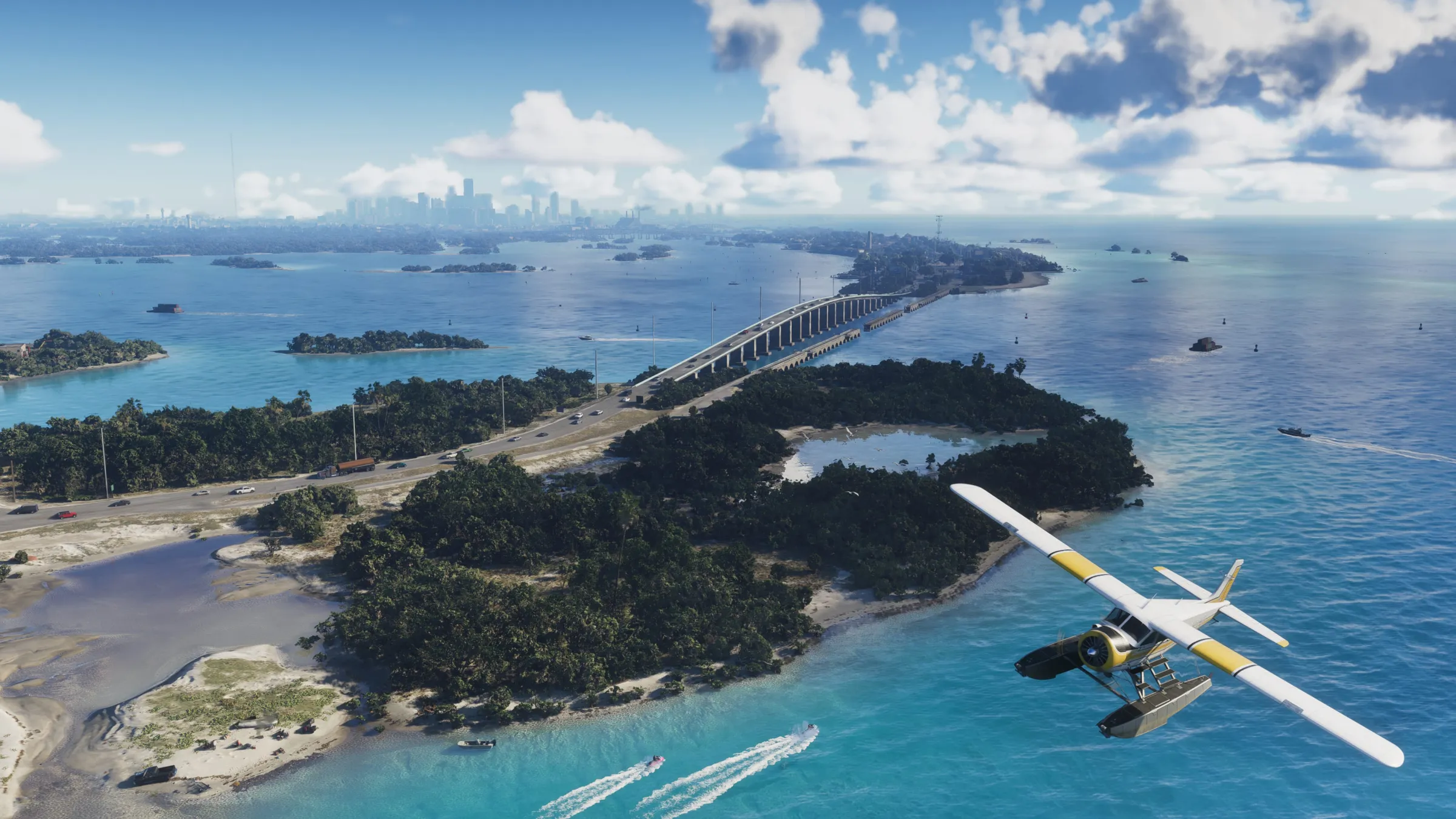 A seaplane flies over turquoise coastal water and small islands linked by a long bridge on a clear day.