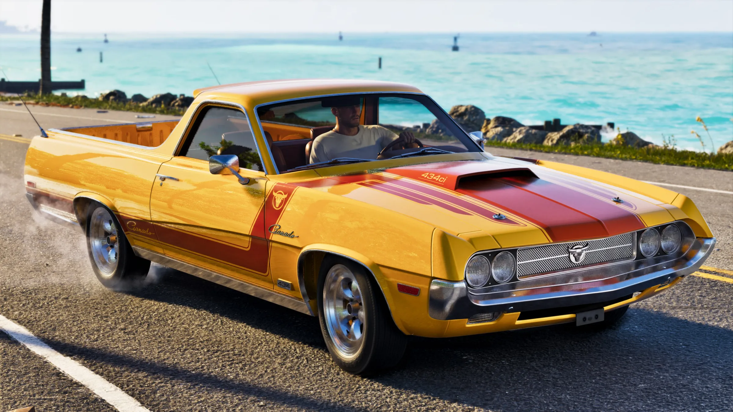 A yellow pickup with red racing stripes travels beside bright turquoise coastal water on a sunny day.